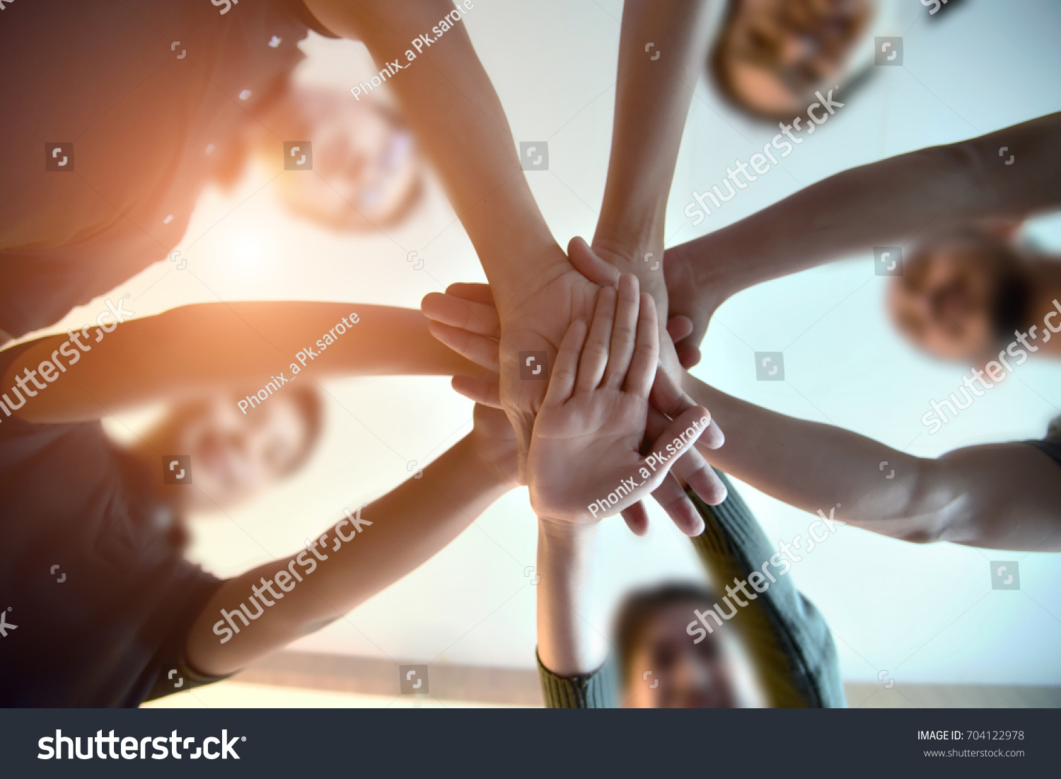 Young group are join hands for working the job success , Hands, symbolizing the hands to unity and teamwork ,success ,helps , business concept.  #704122978