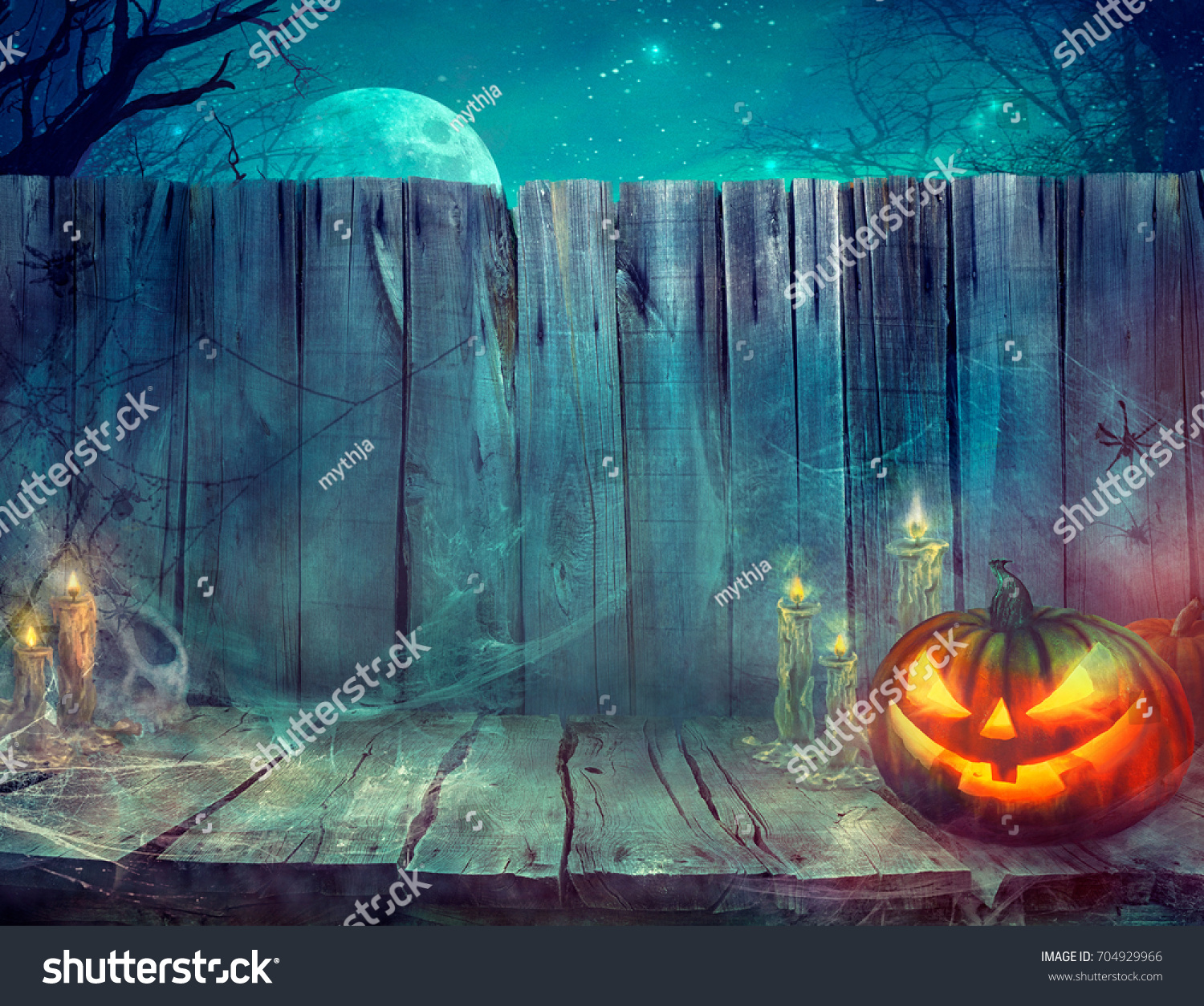 Halloween background. Spooky pumpkin on table. Halloween design with pumpkins and skull #704929966