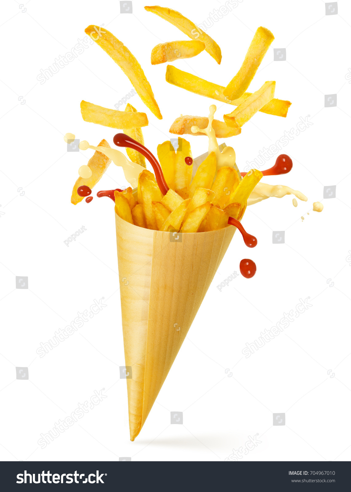 french fries, mayo and ketchup spilling out of a paper cone  #704967010