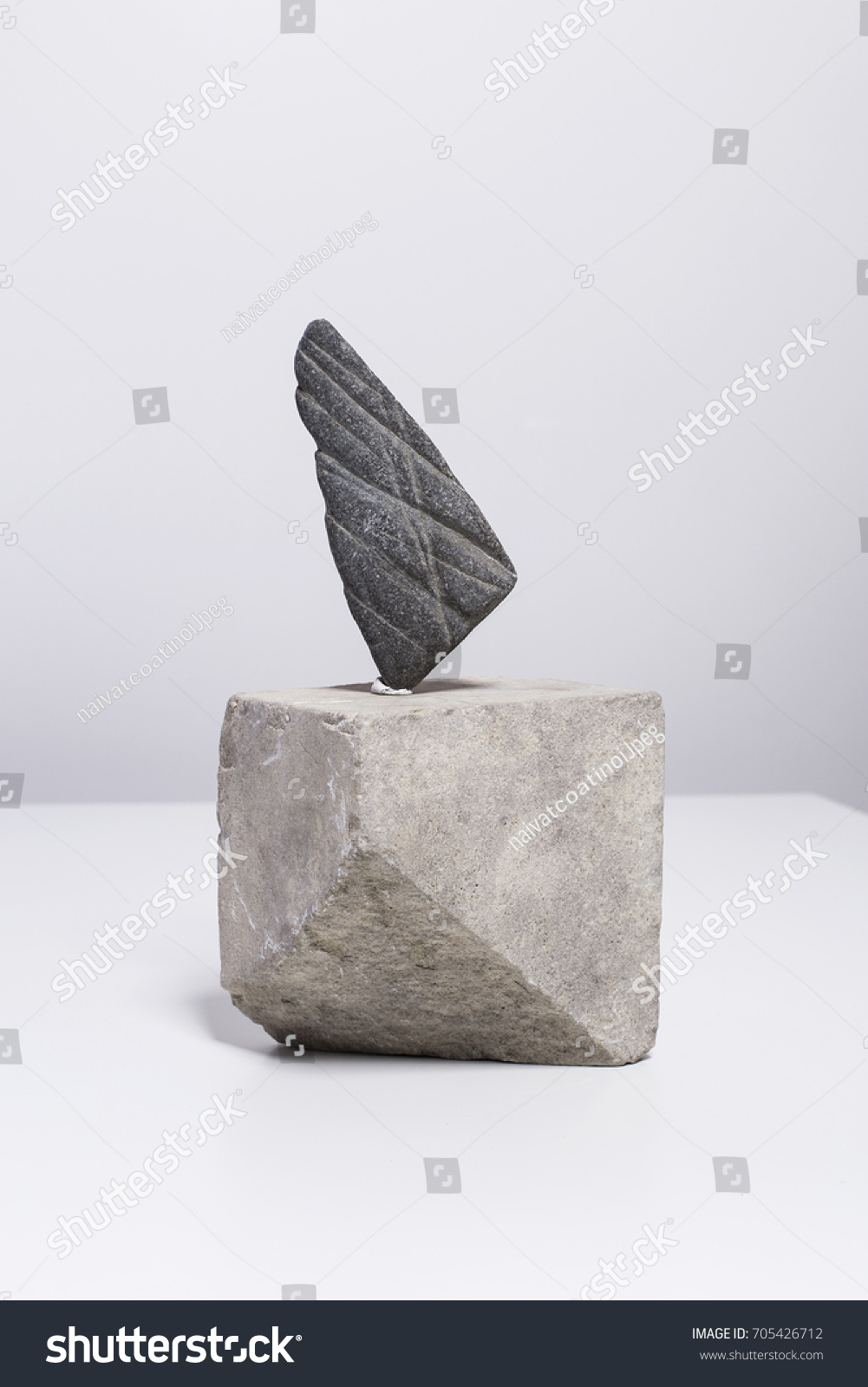 Creative arrangement, minimalistic home decor with sculpture made of river stone #705426712