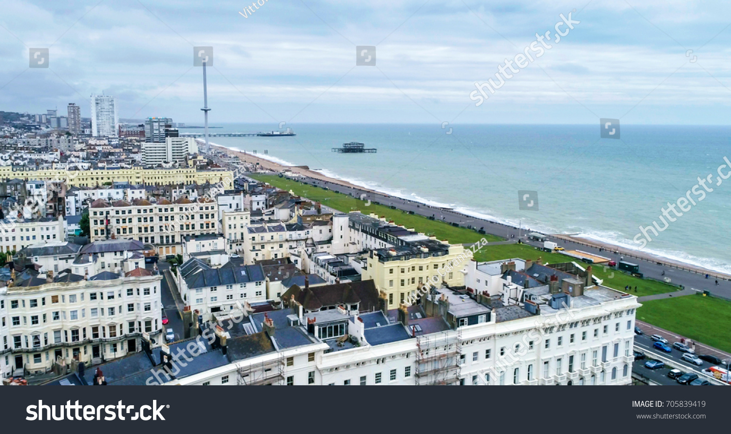 Aerial view of the town of Brighton and Hove towards the beach and the two piers #705839419