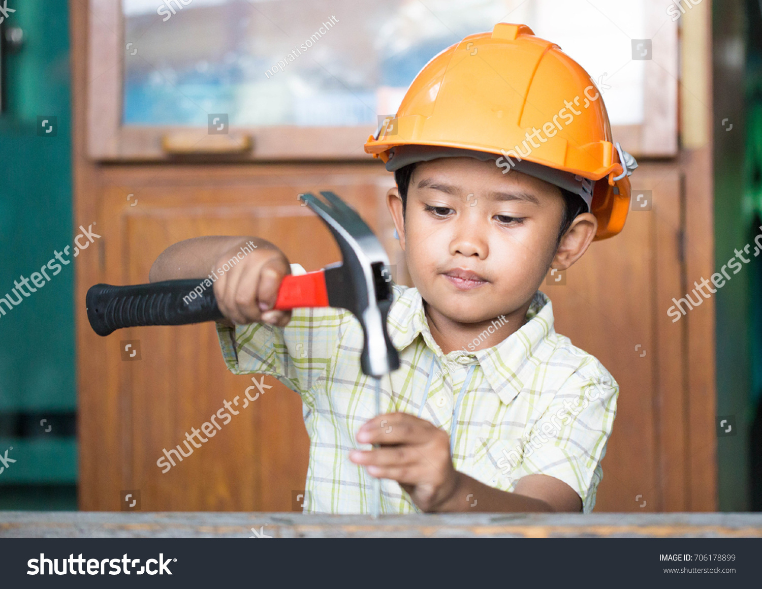 Children use a hammer to nail. #706178899