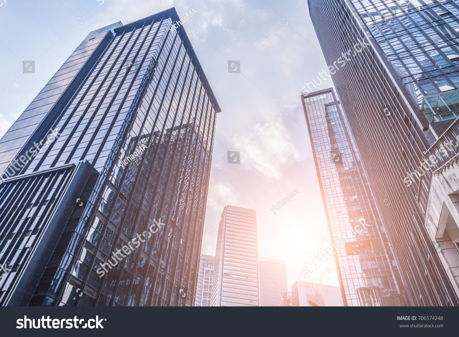 Common modern business skyscrapers, high-rise buildings, architecture raising to the sky, sun. Concepts of financial, economics,  #706574248