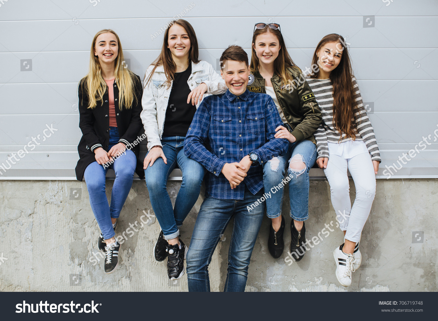 Summer holidays and teenage concept - group of smiling teenagers with skateboard hanging out outside. #706719748