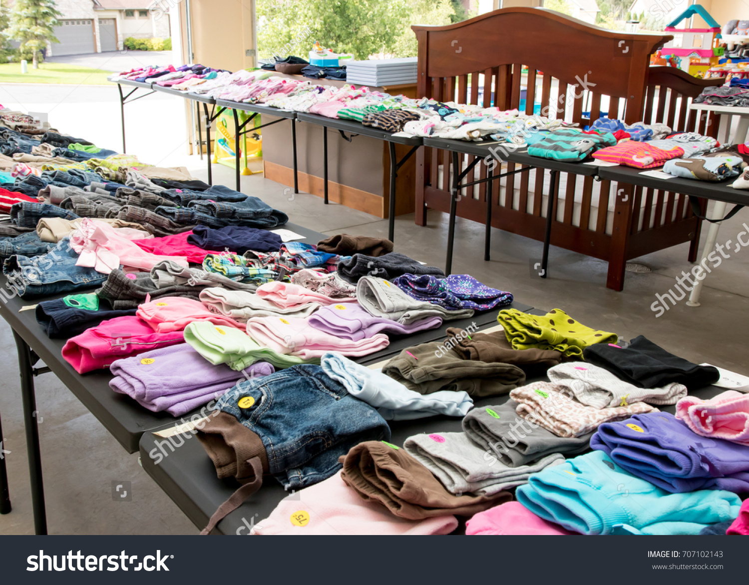 Garage sale tables with clothing #707102143
