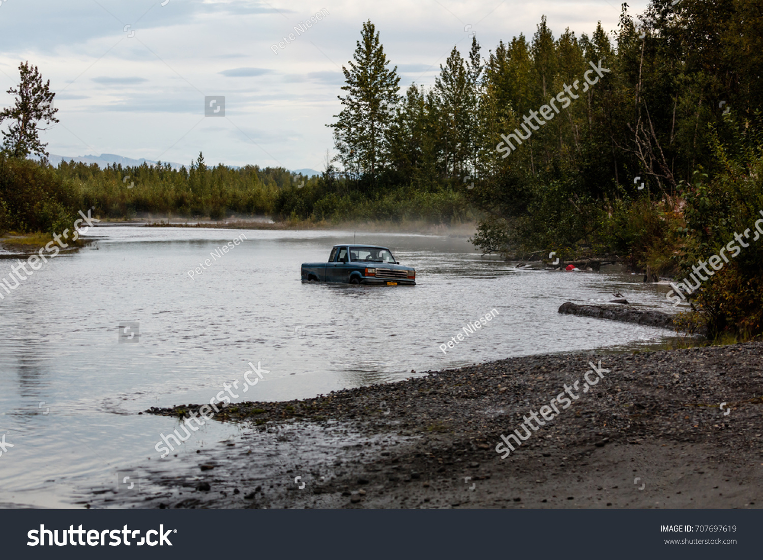 Pickup truck abandoned in high waters of Alaska river #707697619