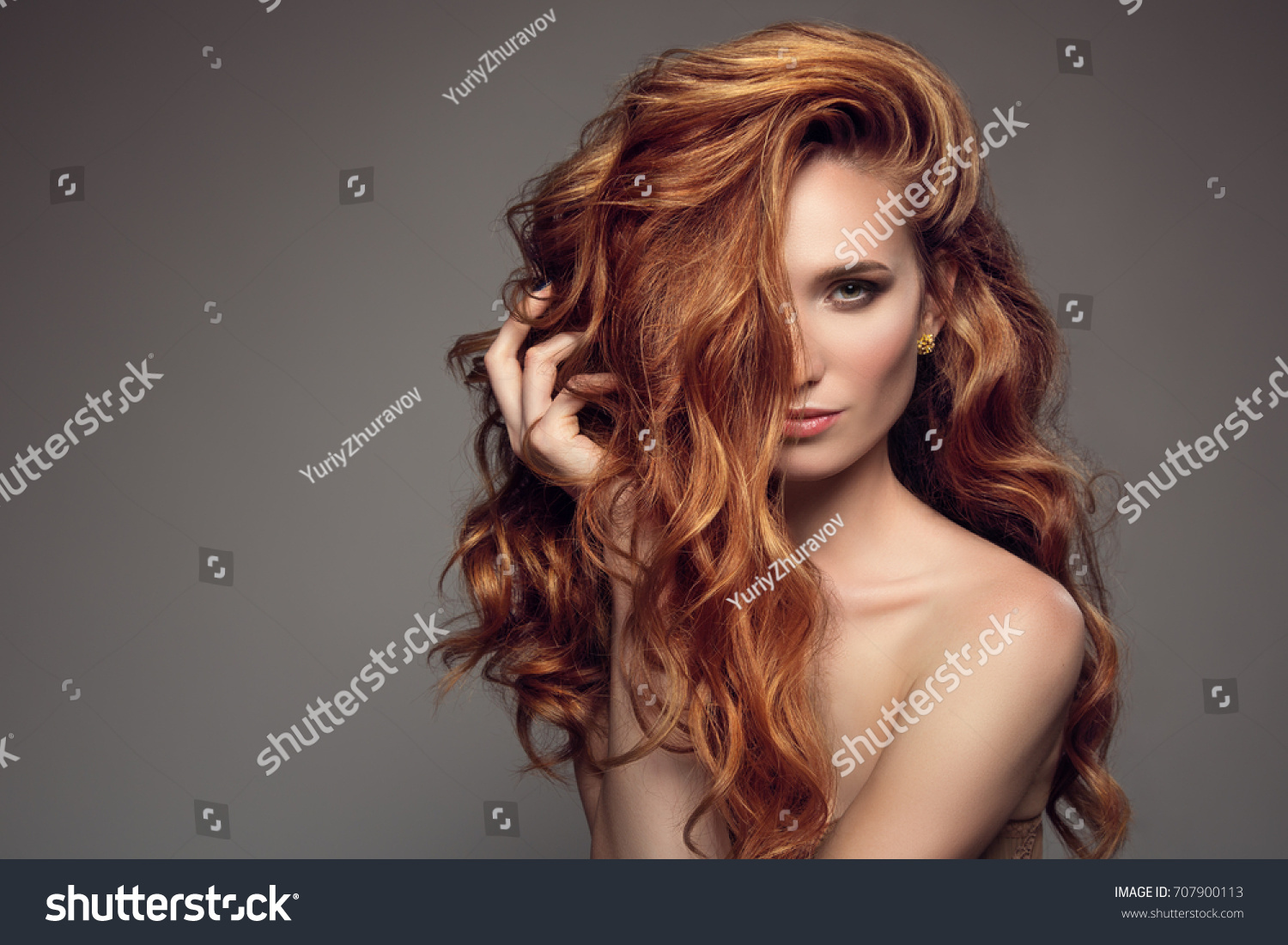 Portrait of woman with long curly beautiful ginger hair.  #707900113