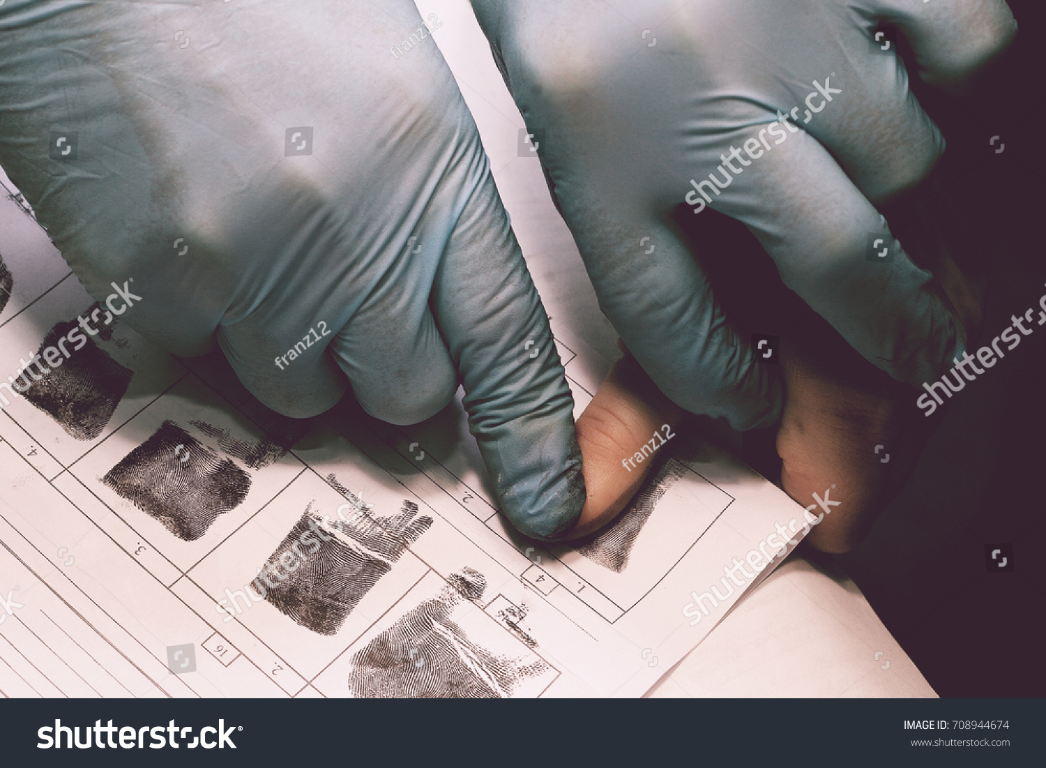 The investigator takes fingerprints from the suspect in the crime. Investigation is a crime. Crime. #708944674
