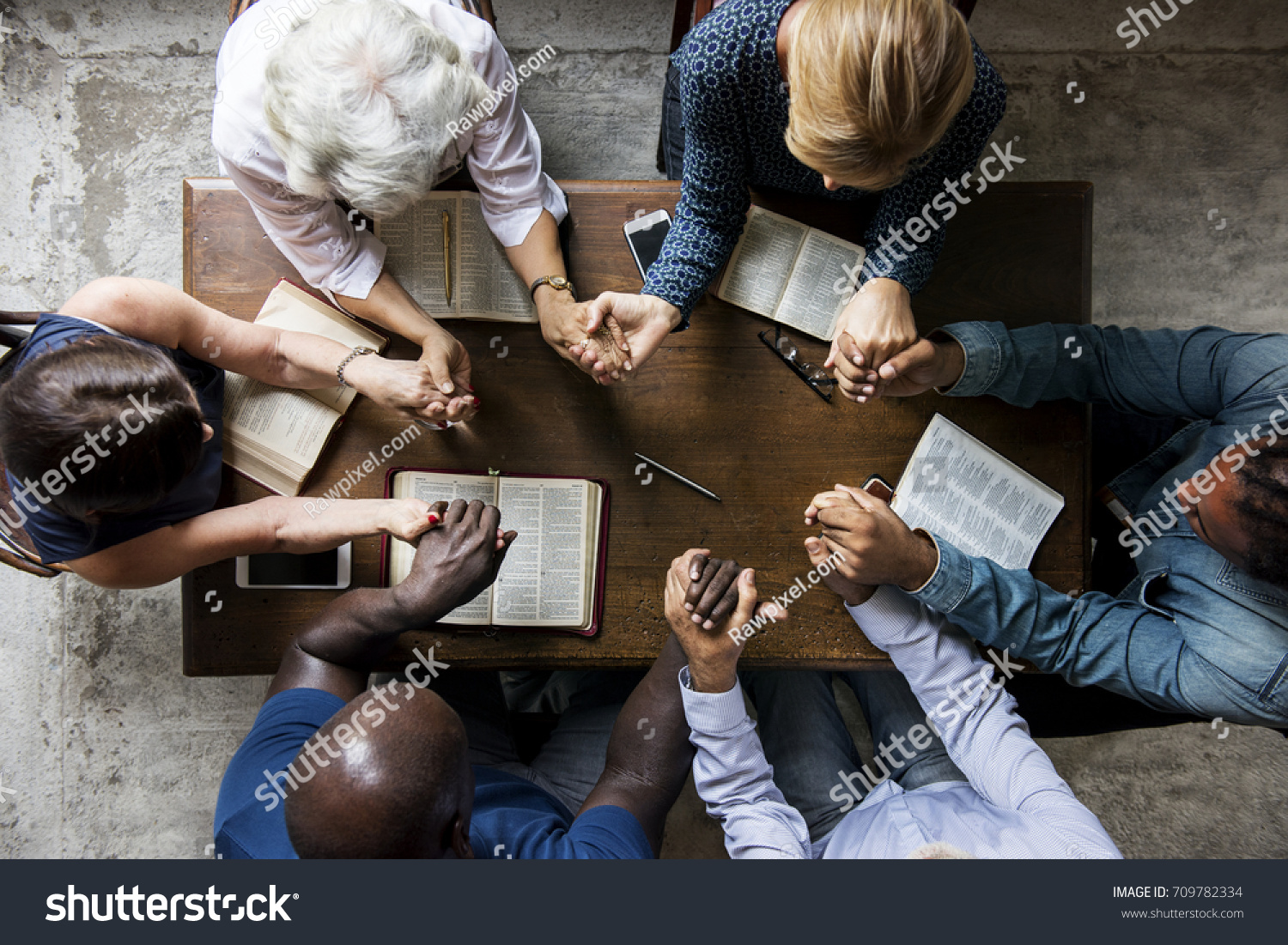 Group of people holding hands praying worship believe #709782334