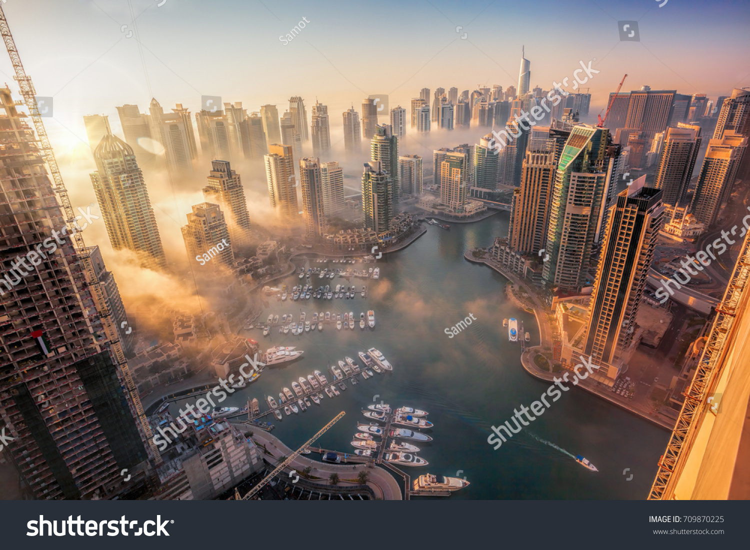 Dubai Marina with colorful sunset in Dubai, United Arab Emirates #709870225
