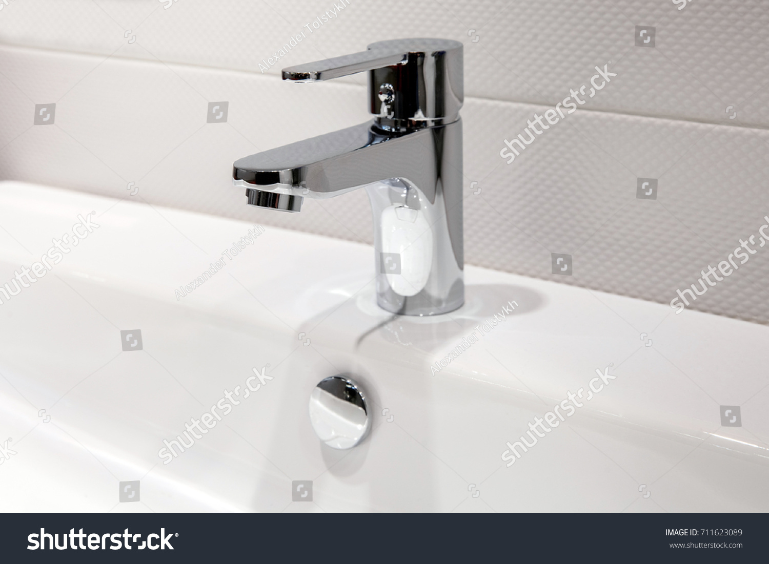 Modern faucet of chrome color in bathroom interior #711623089