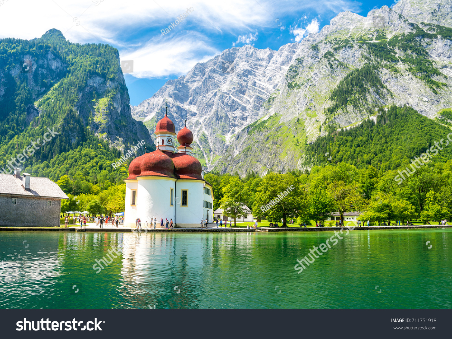 Konigsee lake with st Bartholomew church surrounded by mountains, Berchtesgaden National Park, Bavaria, Germany #711751918
