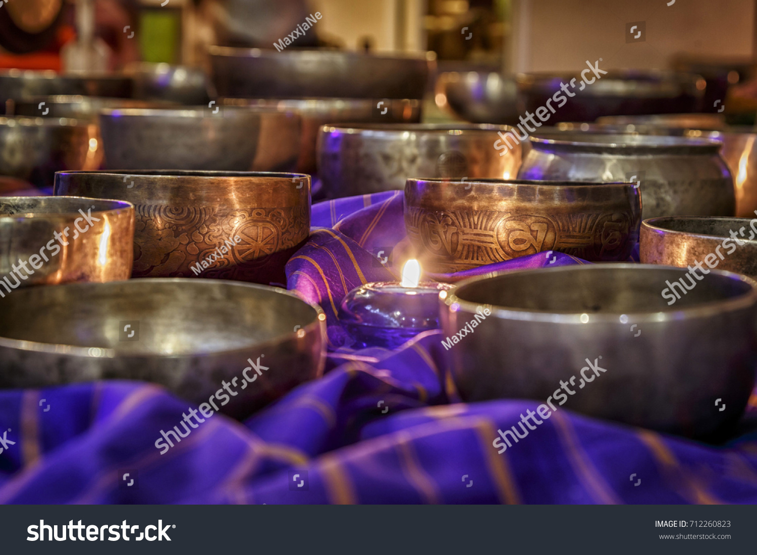 singing bowls lit by candlelight #712260823