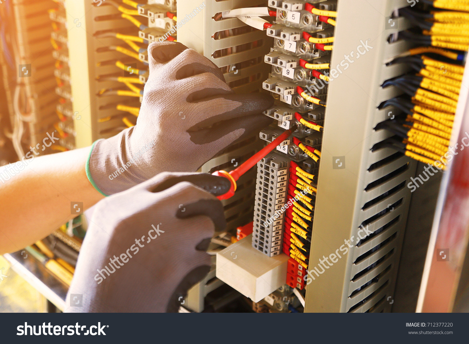 Electrical terminal in junction box and service by technician. Electrical device install in control panel for support program and control function by PLC. routine visit check equipment by technician. #712377220