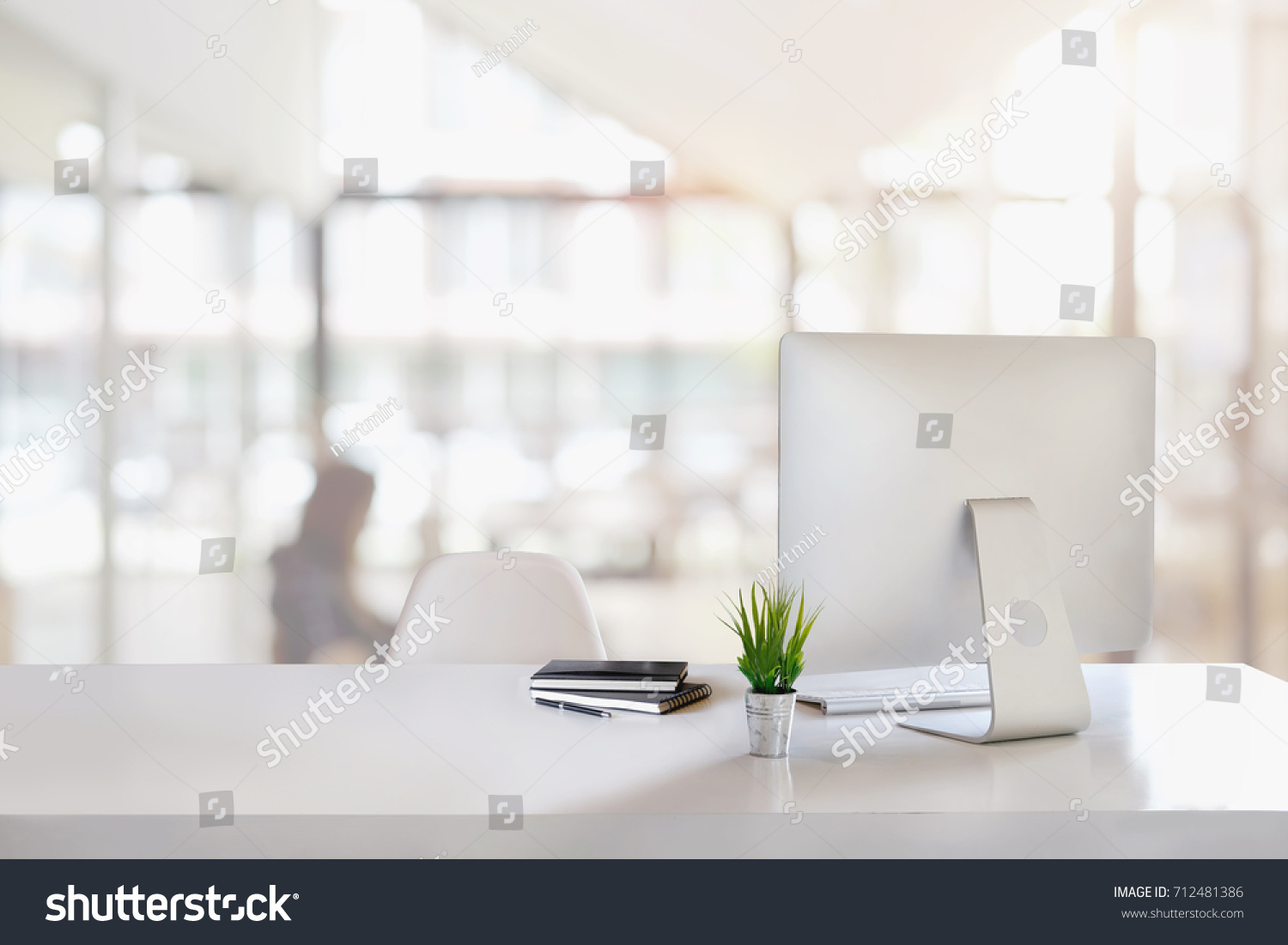 Stylish workspace with desktop computer, office supplies, houseplant and books at office. desk work concept. #712481386