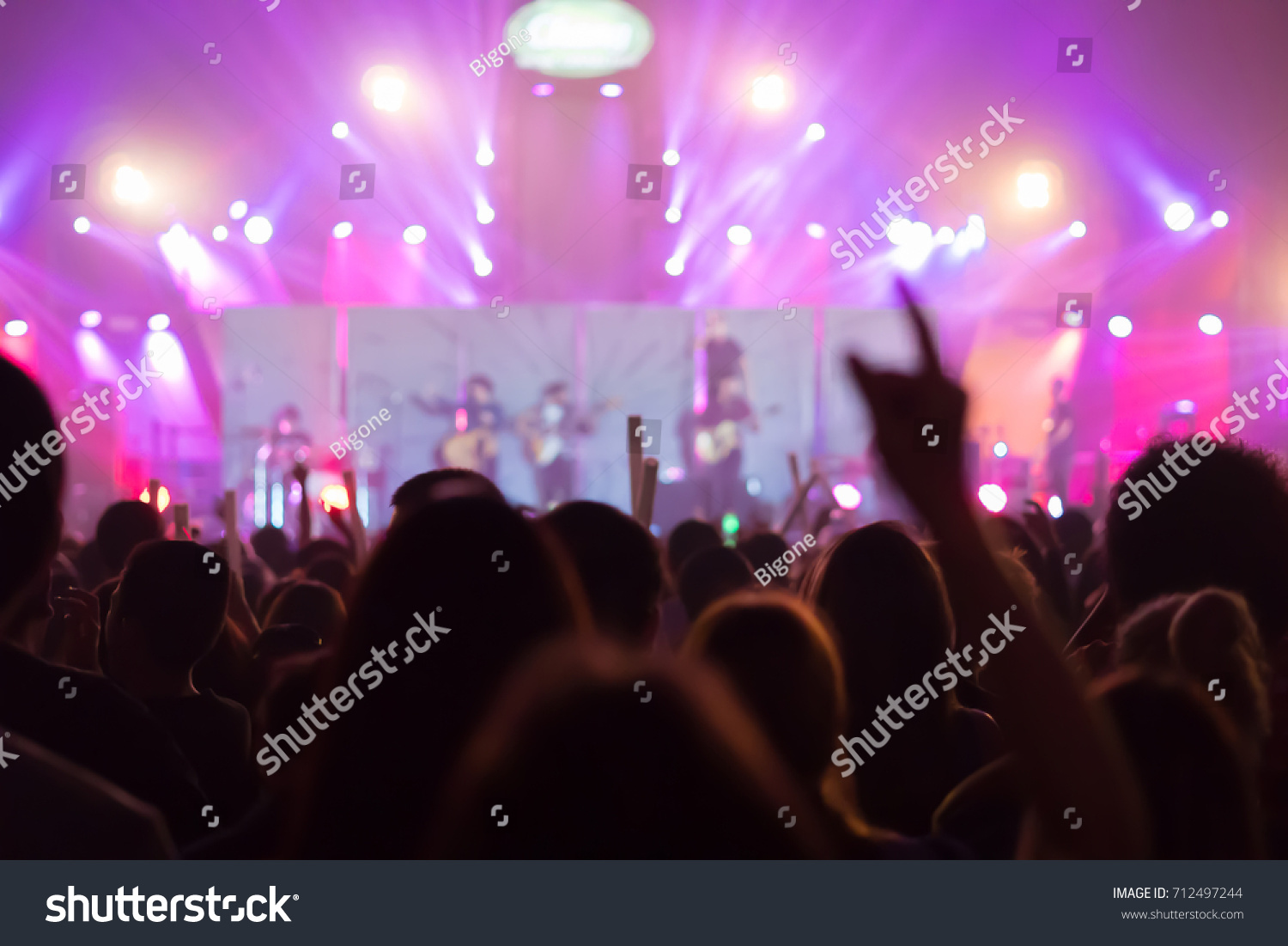 Silhouette hands of audience crowd people  enjoying the club party concert ,Celebrate new year party , Blurry night club party music dancing sound , Party People Blurred Background #712497244
