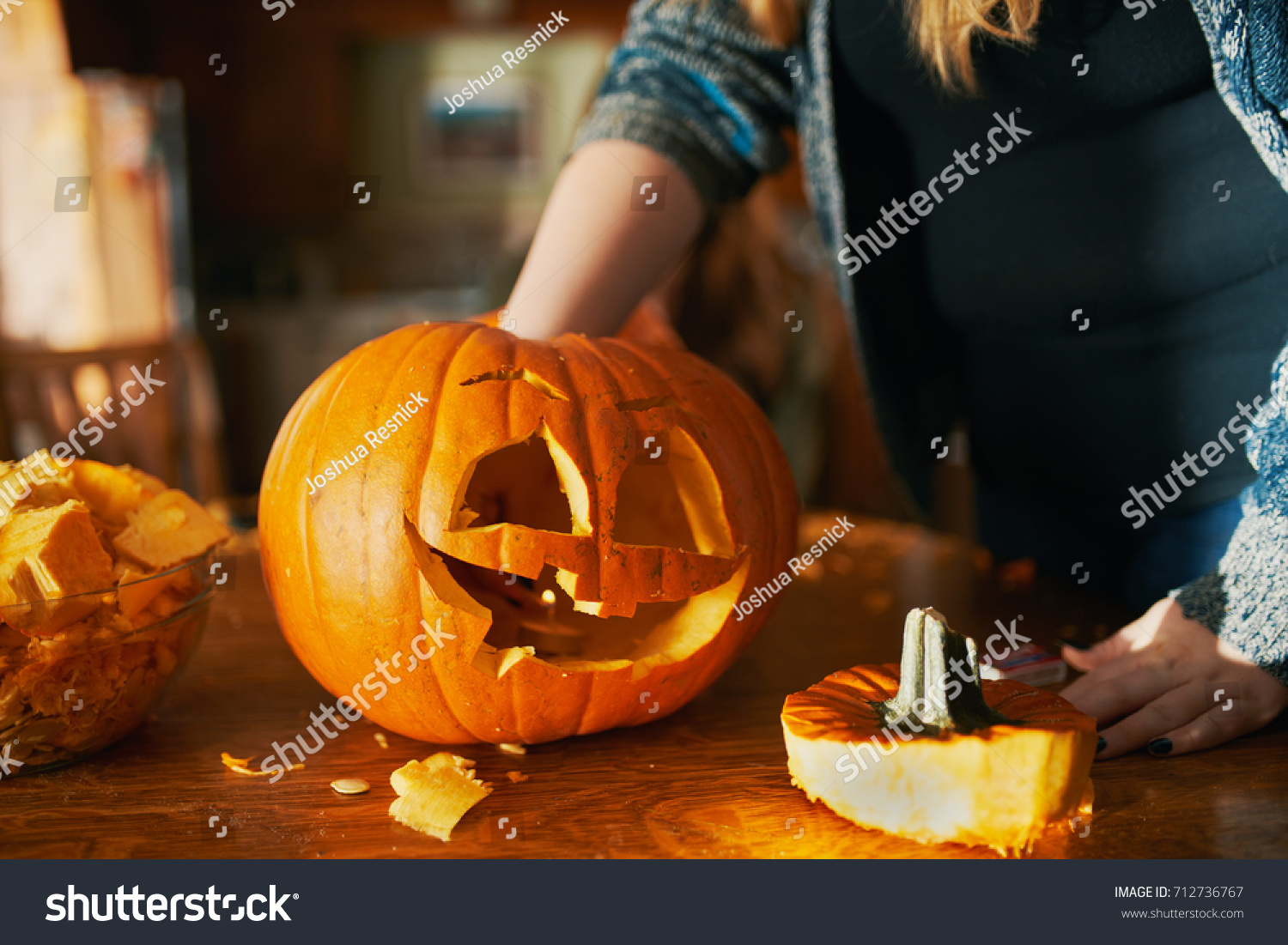 family fun activity - carved pumpkins into jack-o-lanterns for halloween close up #712736767