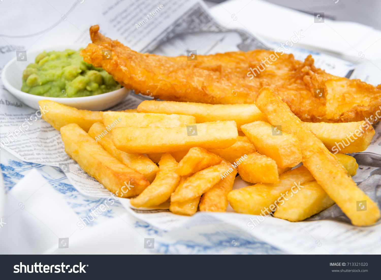 Traditional English Food such as Fish and Chips with mushy peas served in the Pub or Restaurant #713321020