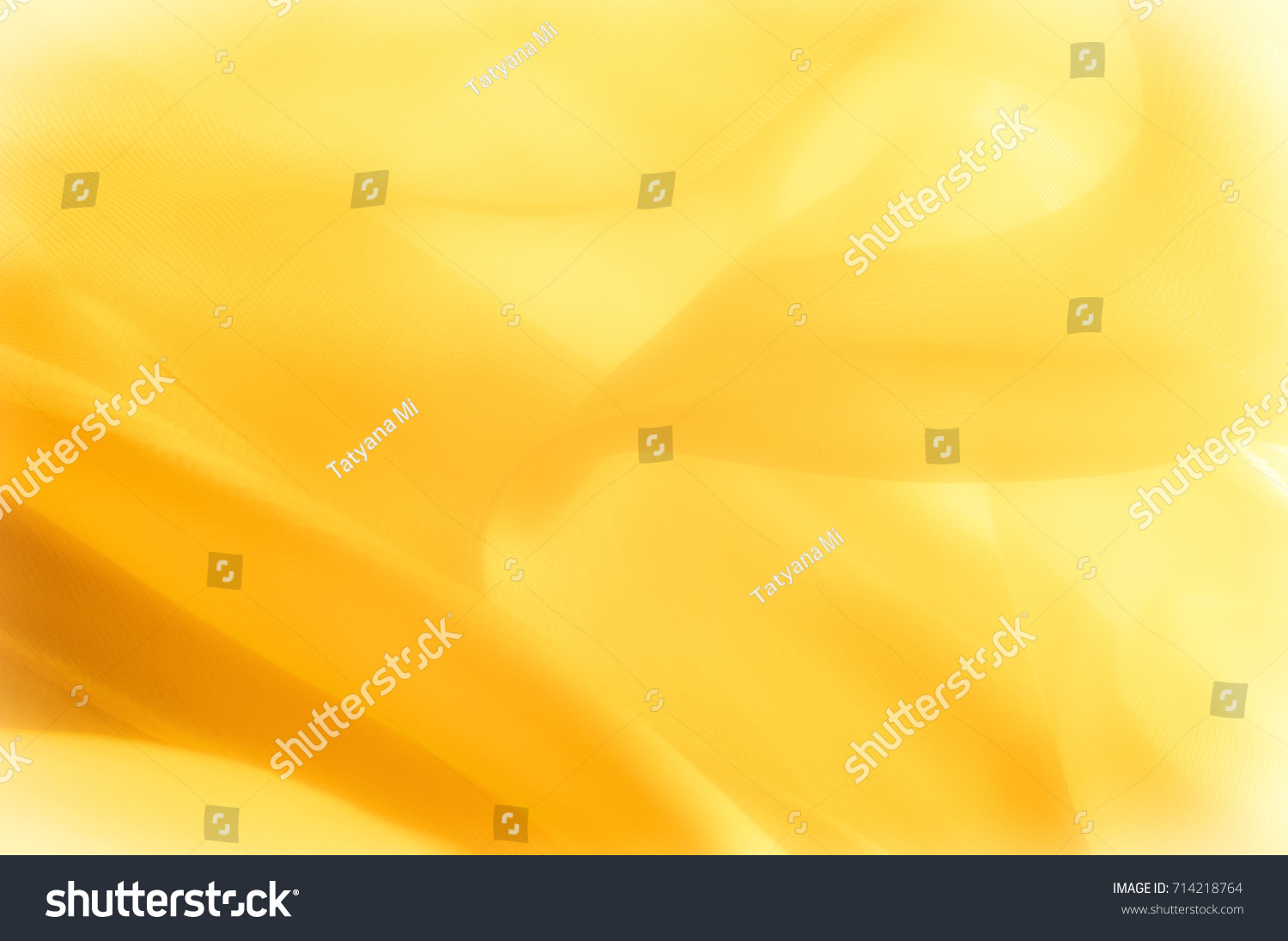 The photo is blurred. Texture, background, pattern. Yellow silk fabric. Abstract background of luxury Yellow fabric or liquid wave or wavy grunge texture. The whole background. #714218764