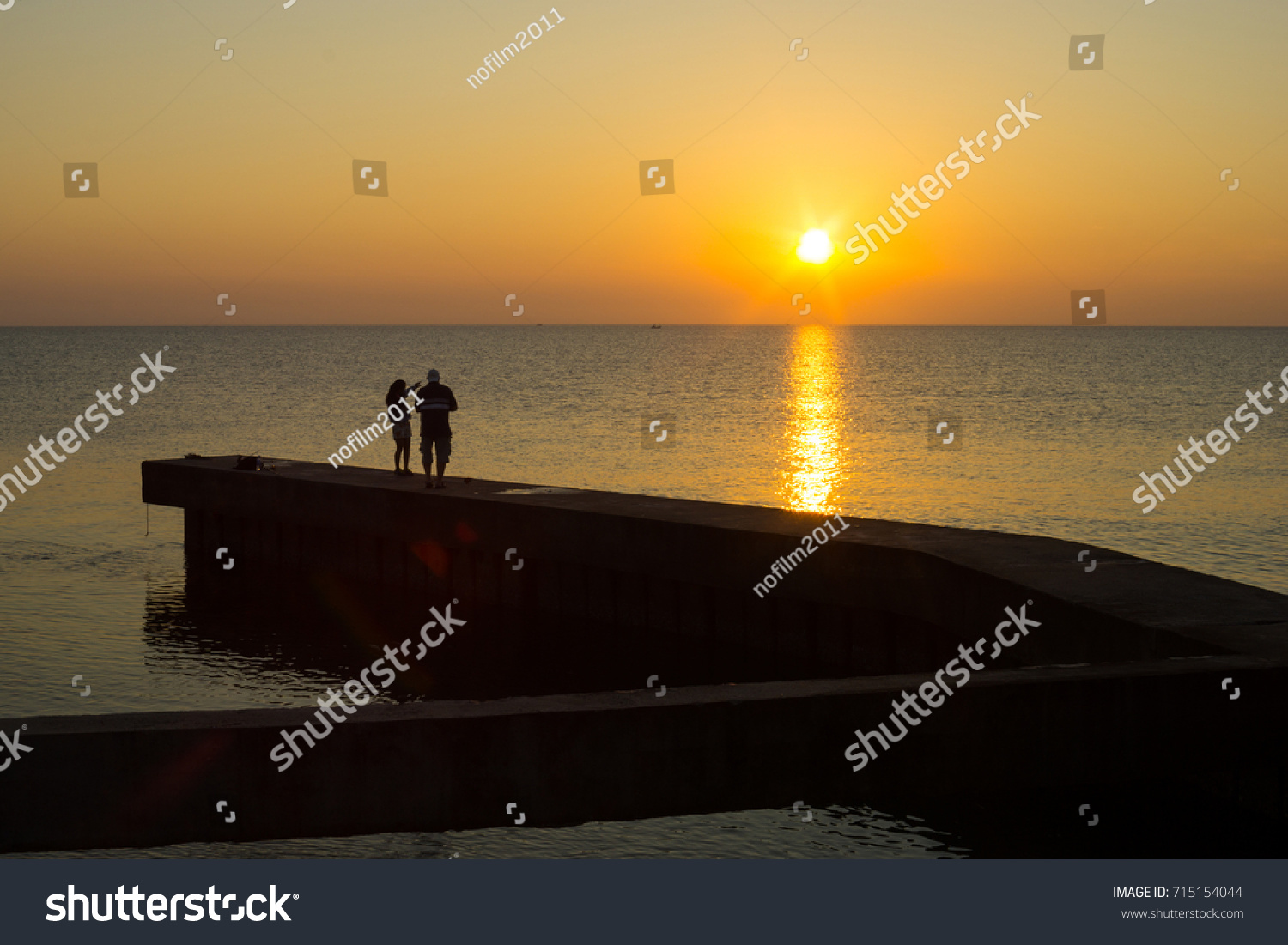 Couple in beautiful morning at the sea. #715154044