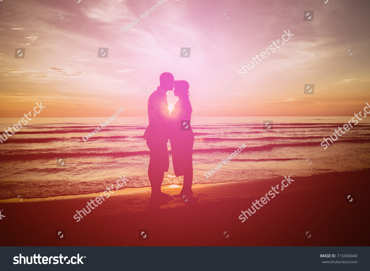 Young people embrace and love each other on the beach during Sunset Amid romanticism Style Silhouette #715494040