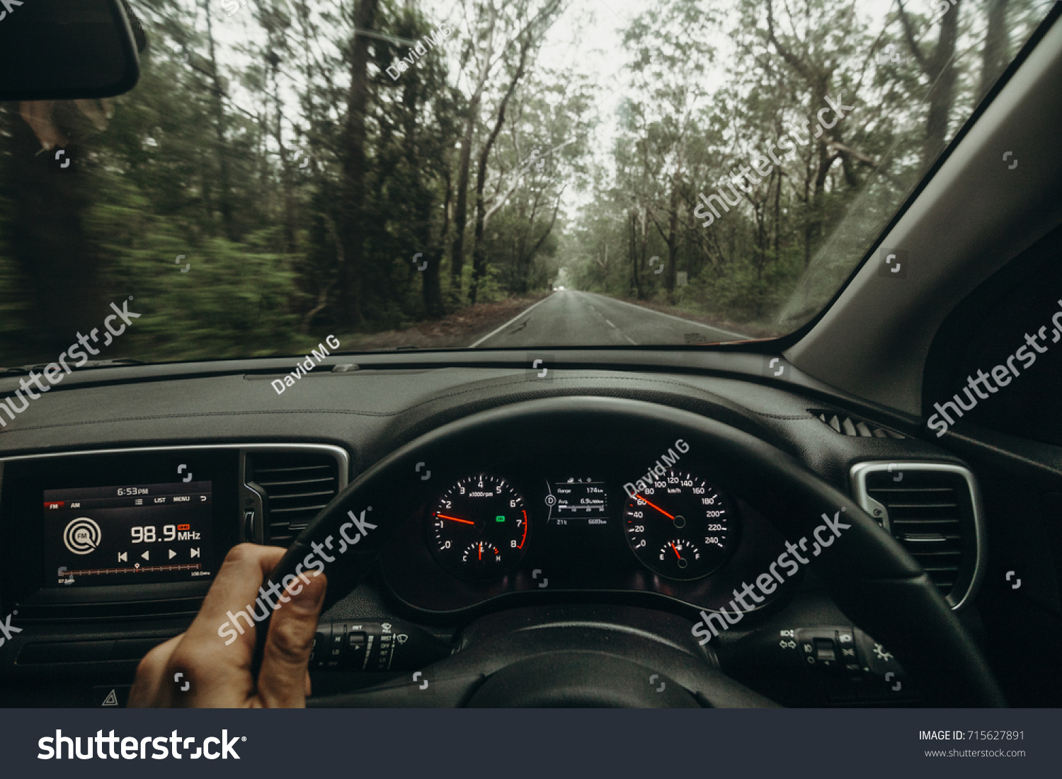 Inside view of car steering wheel while driving across Australian road #715627891
