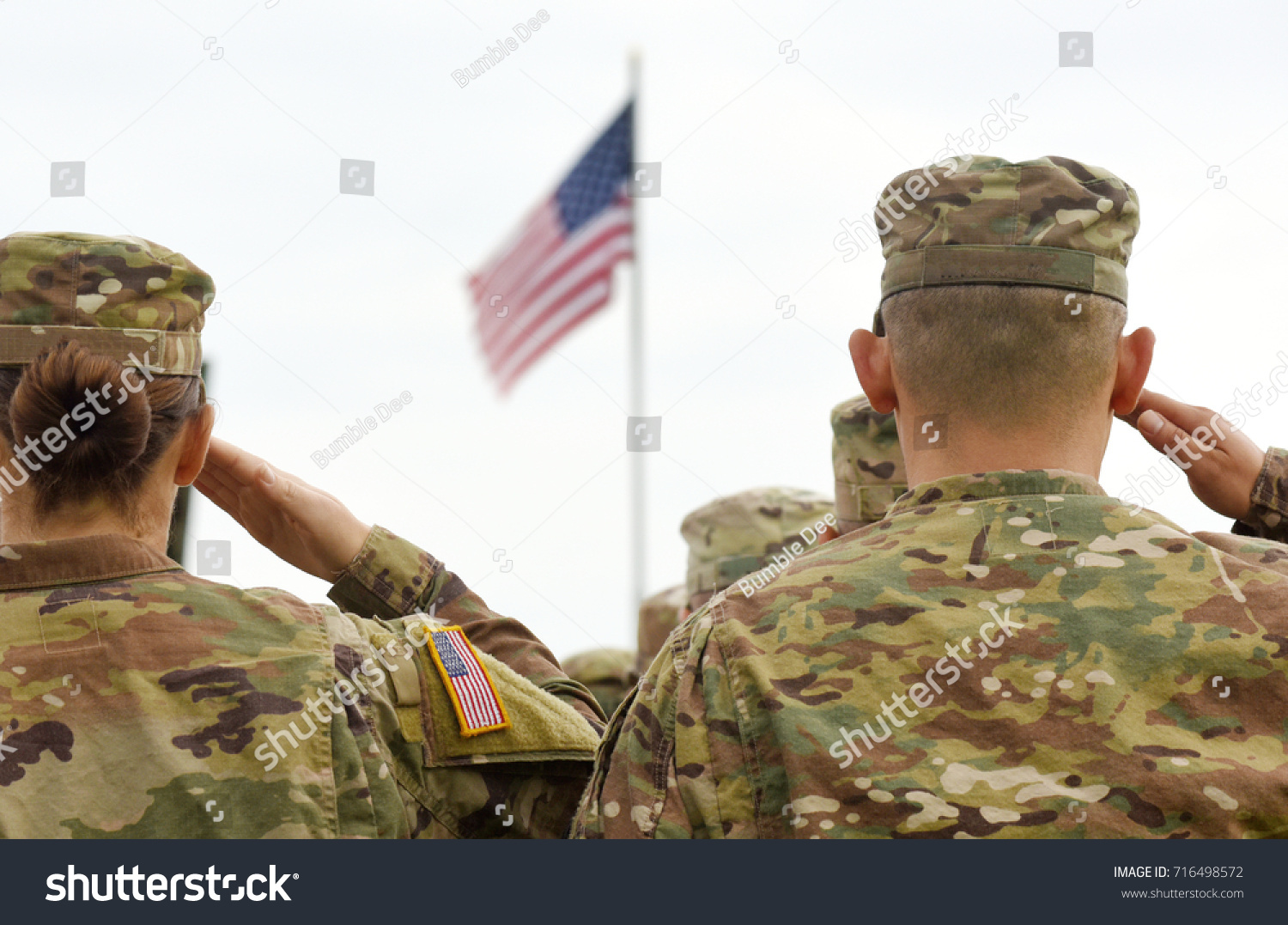 American Soldiers Saluting US Flag #716498572