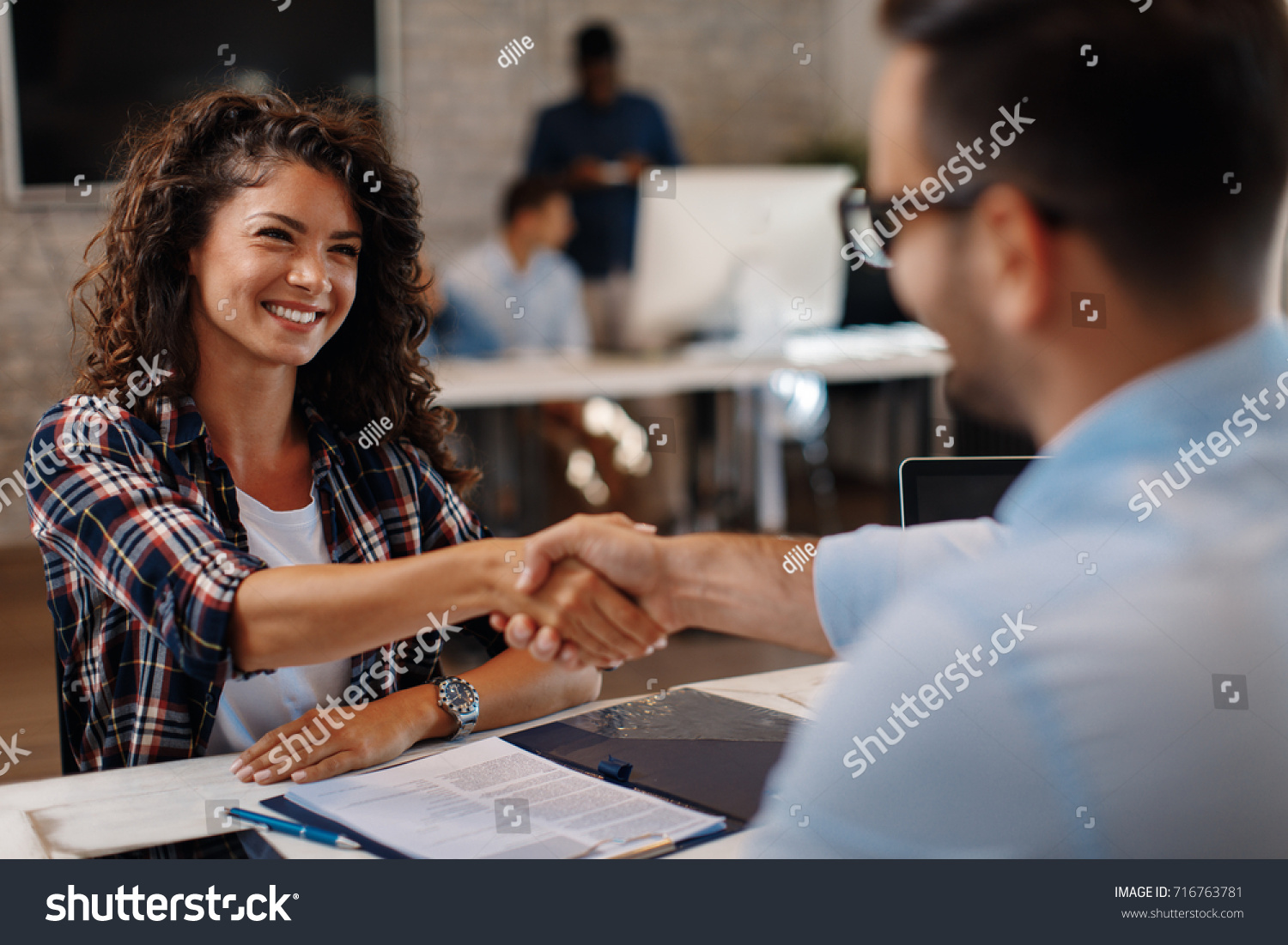 Young woman signing contracts and handshake with a manager #716763781