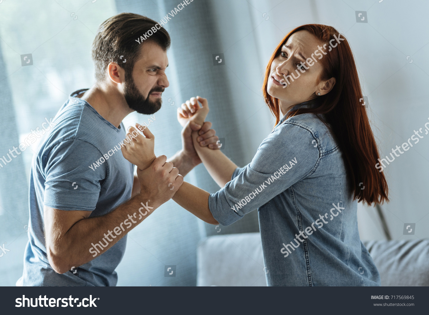 Strong brutal man holding his wife #717569845