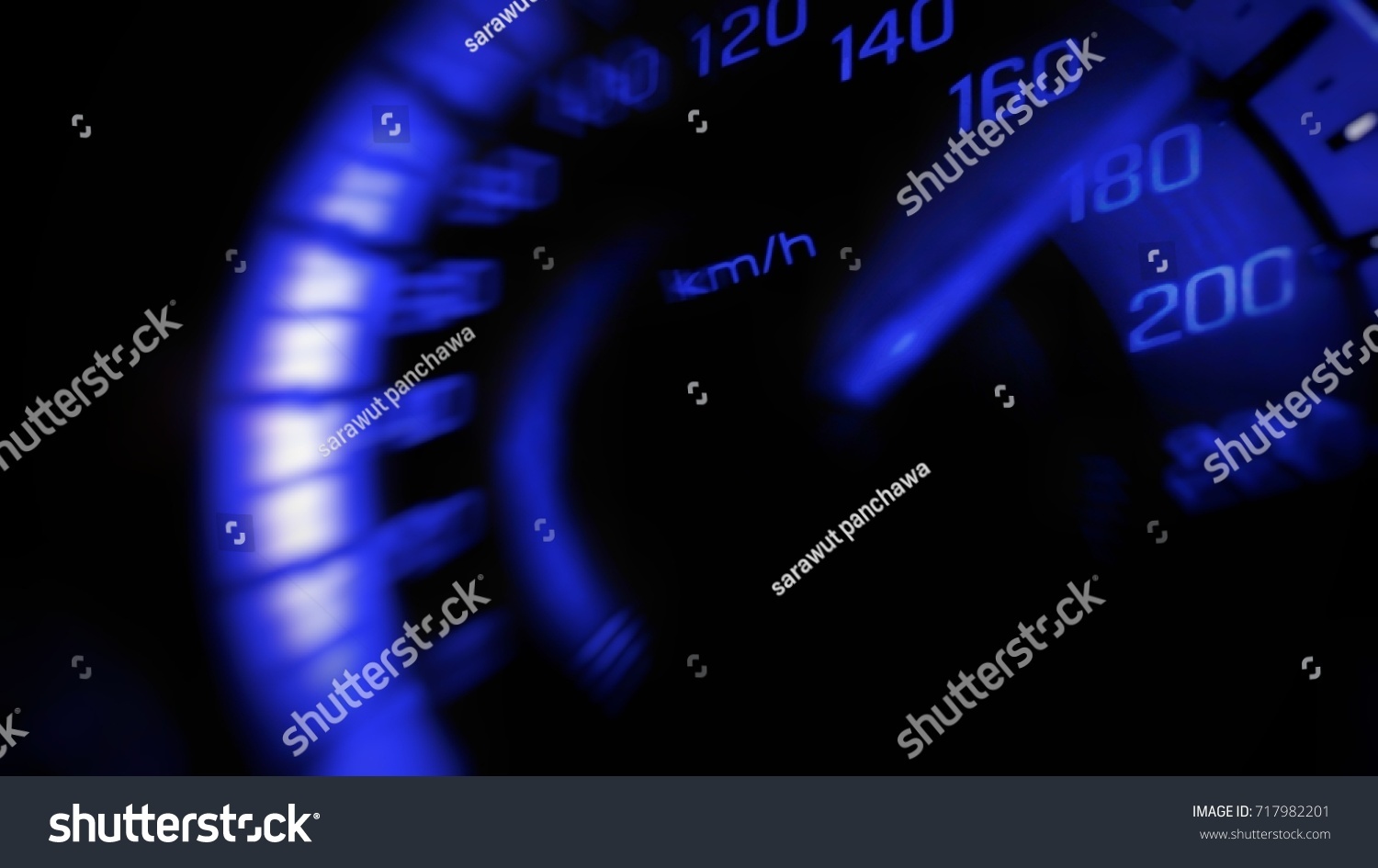 Close up and blurred mile indicator of a speed meter in a car with blue light speed at 180 Km/H in concept racing car #717982201