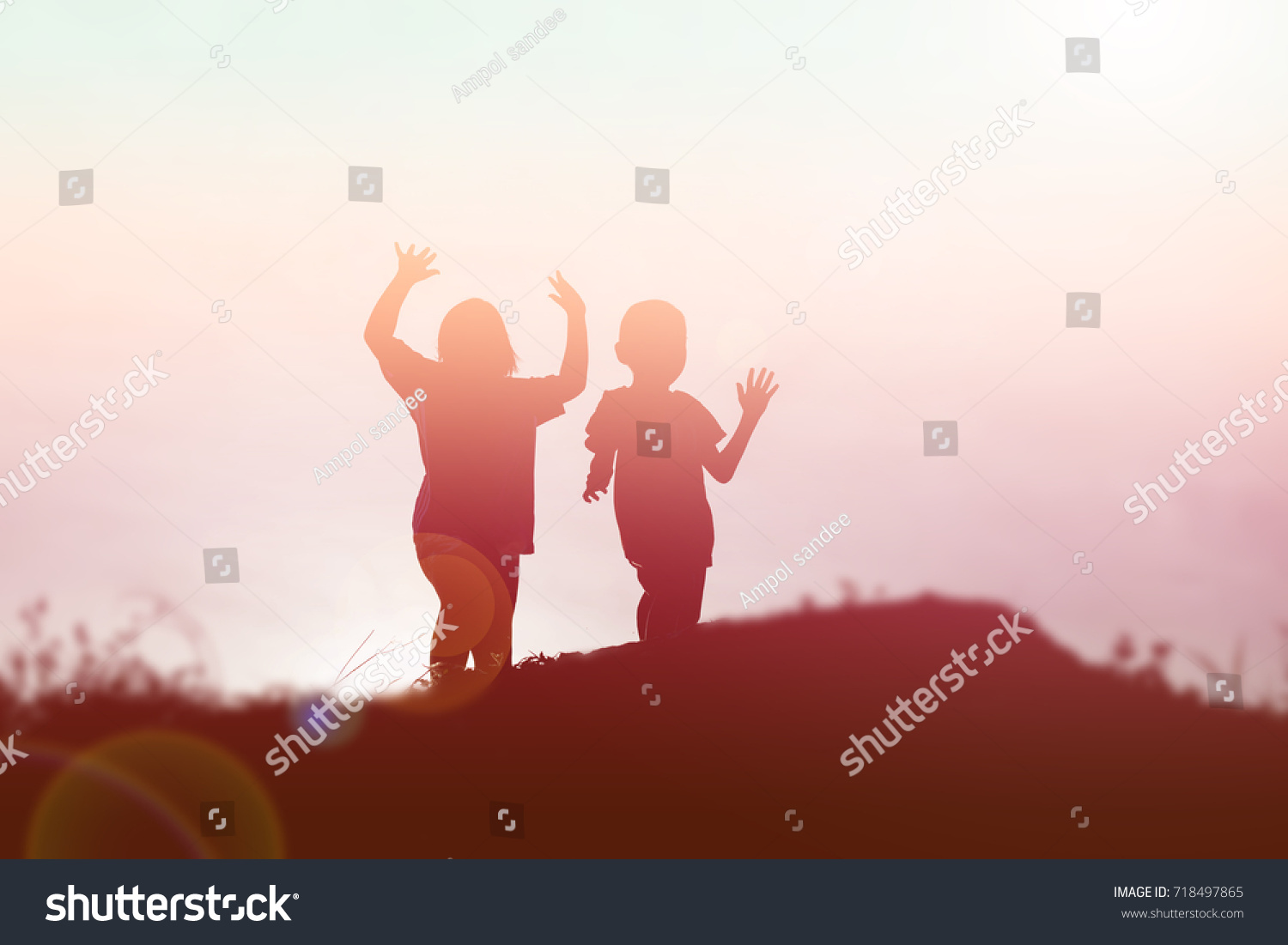 silhouette of a happy children and happy time sunset #718497865
