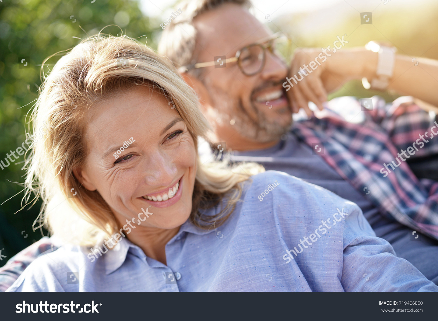 Portrait of mature couple relaxing in outdoor sofa #719466850