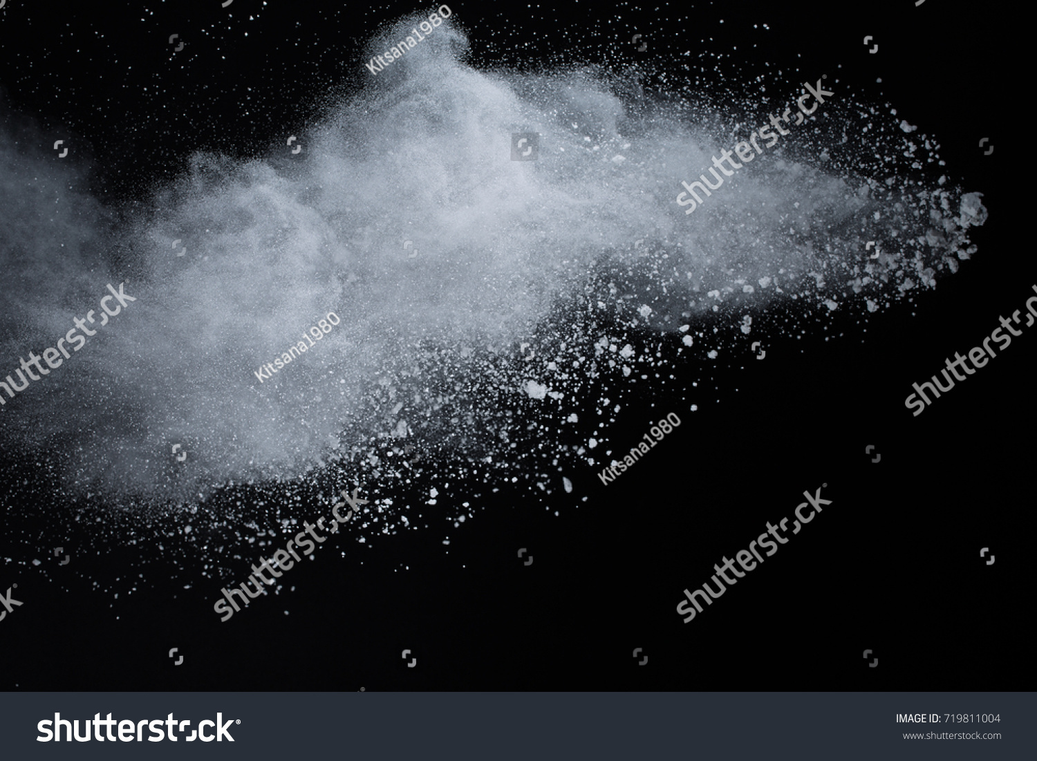 Powder explosion. Closeup of white dust particle explosion isolated on black background
 #719811004