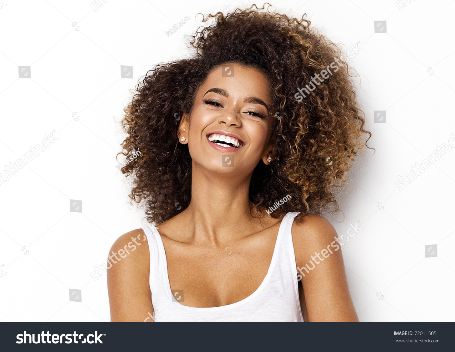 Beautiful african american girl with an afro hairstyle smiling #720115051