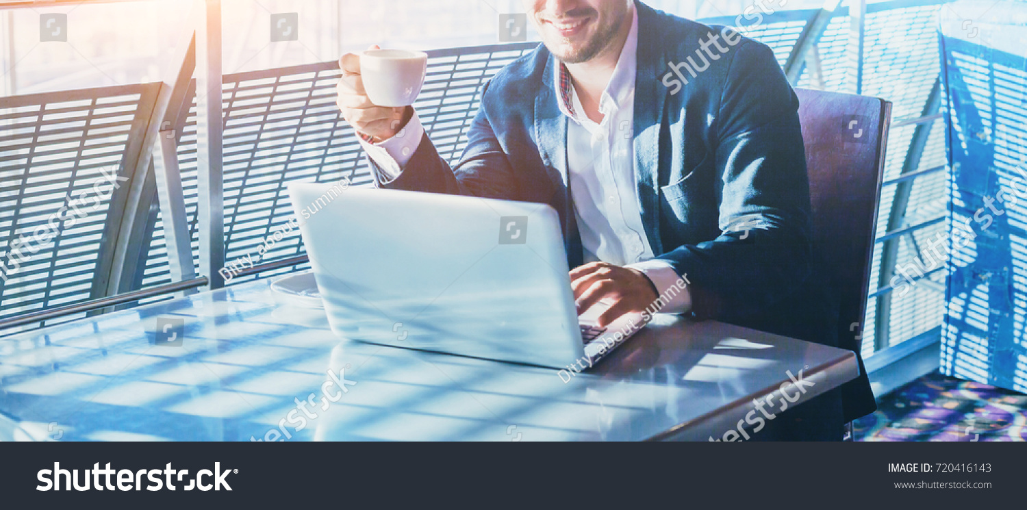 businessman working on computer, drinking coffee and smiling, abstract business banner background with place for text #720416143