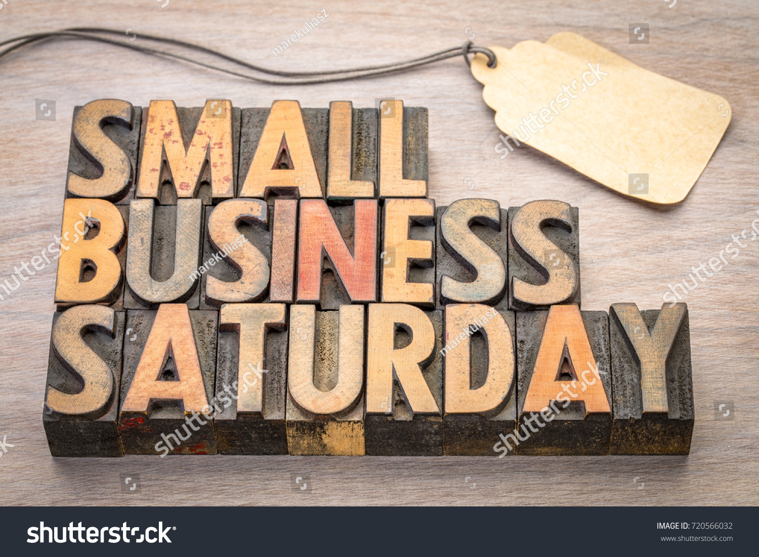 Small Business Saturday word abstract - text in vintage letterpress wood type with a blank price tag, holiday shopping concept #720566032