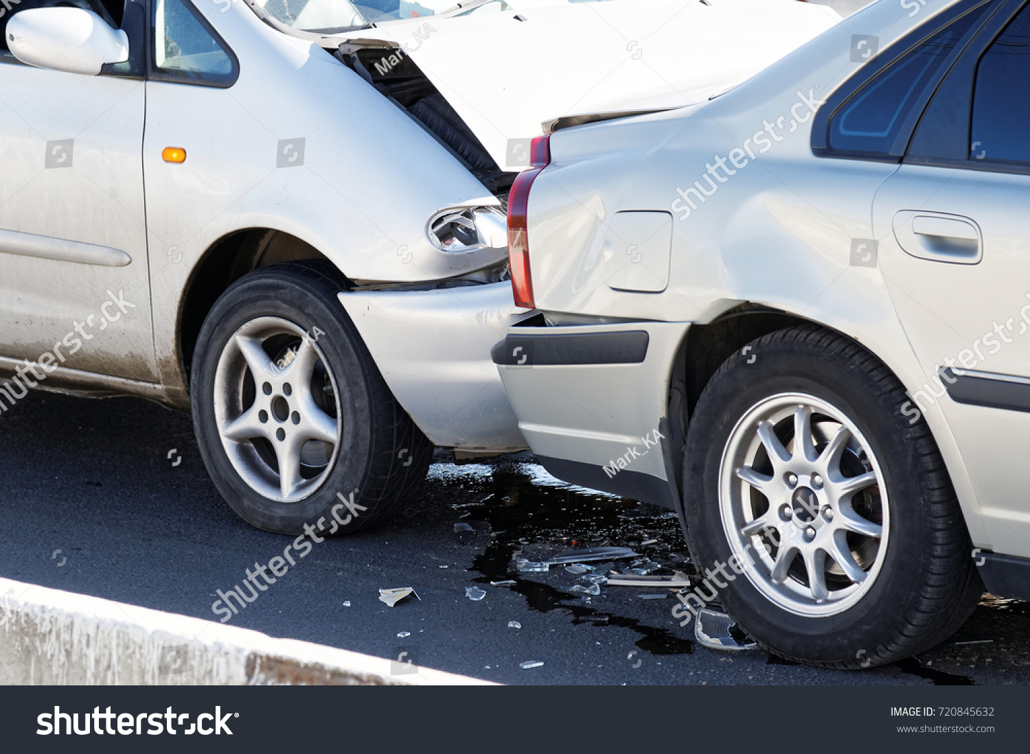 Two cars in a car accident on street. Closeup damaged automobiles after collision in city. Insurance case. #720845632