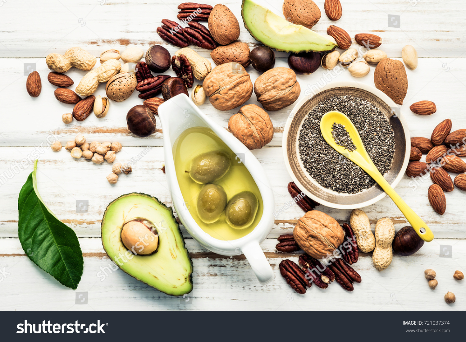 Selection food sources of omega 3 and unsaturated fats. Superfood high vitamin e and dietary fiber for healthy food. Almond ,pecan,hazelnuts,walnuts and olive oil on stone background. #721037374
