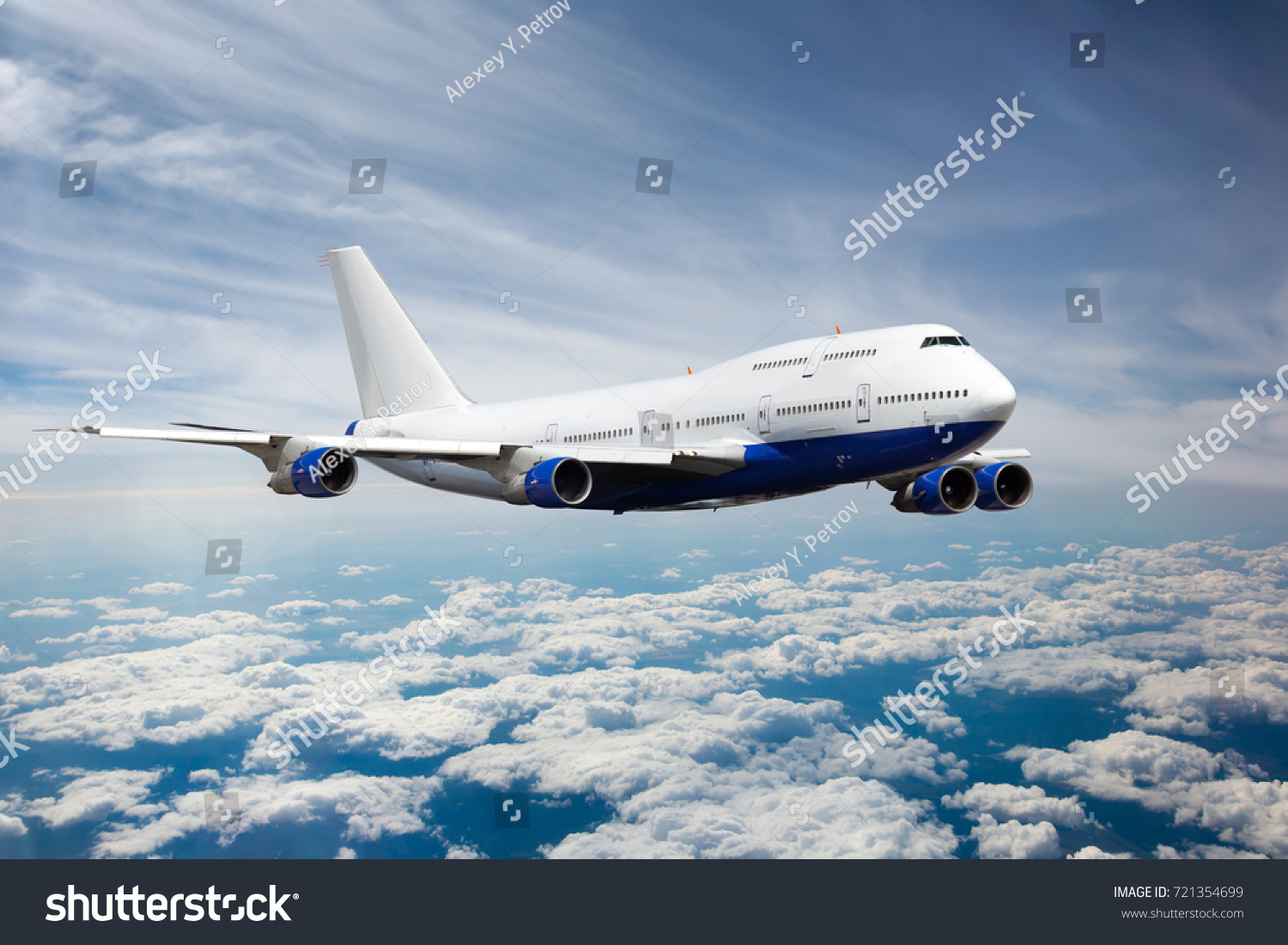 Passenger jet plane in the sky. Airplane flies high above the clouds. #721354699