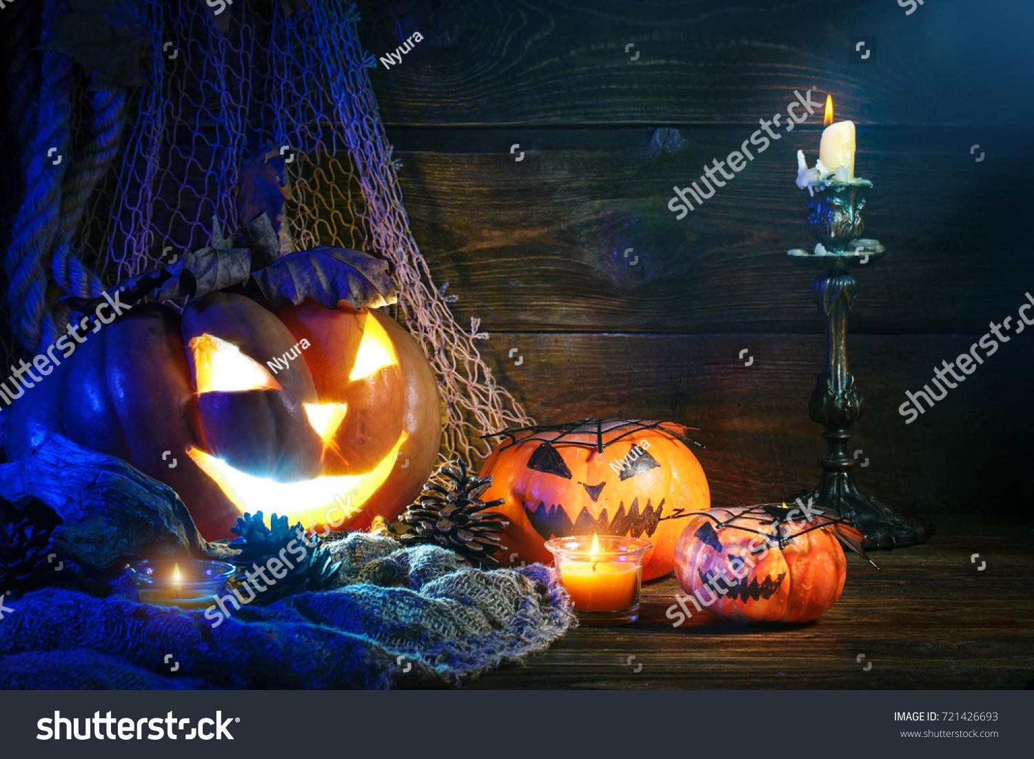 Halloween pumpkins on a wooden table at night. #721426693