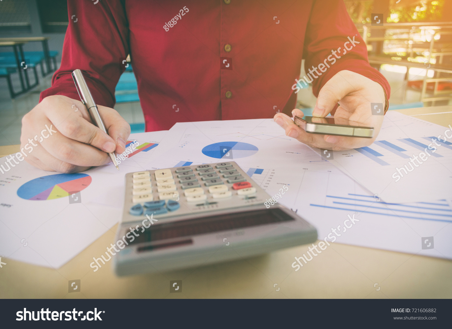 hand working writing and using smart phone with business strategy diagram report, calculator on desk at home office, income and expenses, finance, searching data, money cost savings, economy concept #721606882