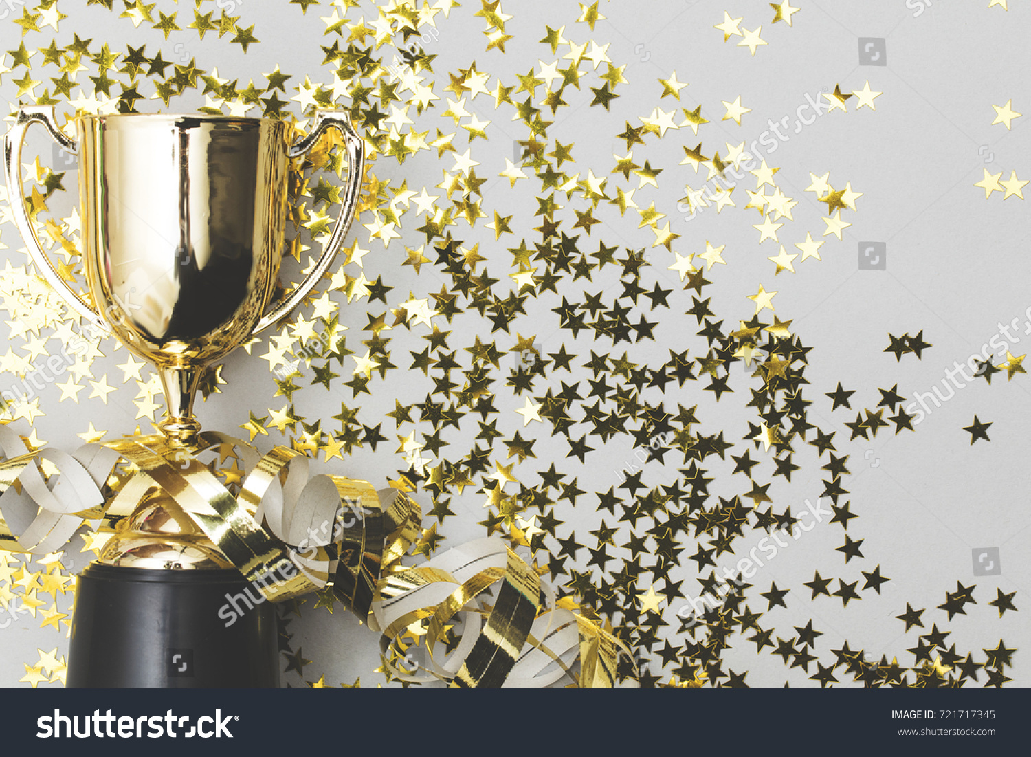 Gold winners trophy with golden shiny stars #721717345