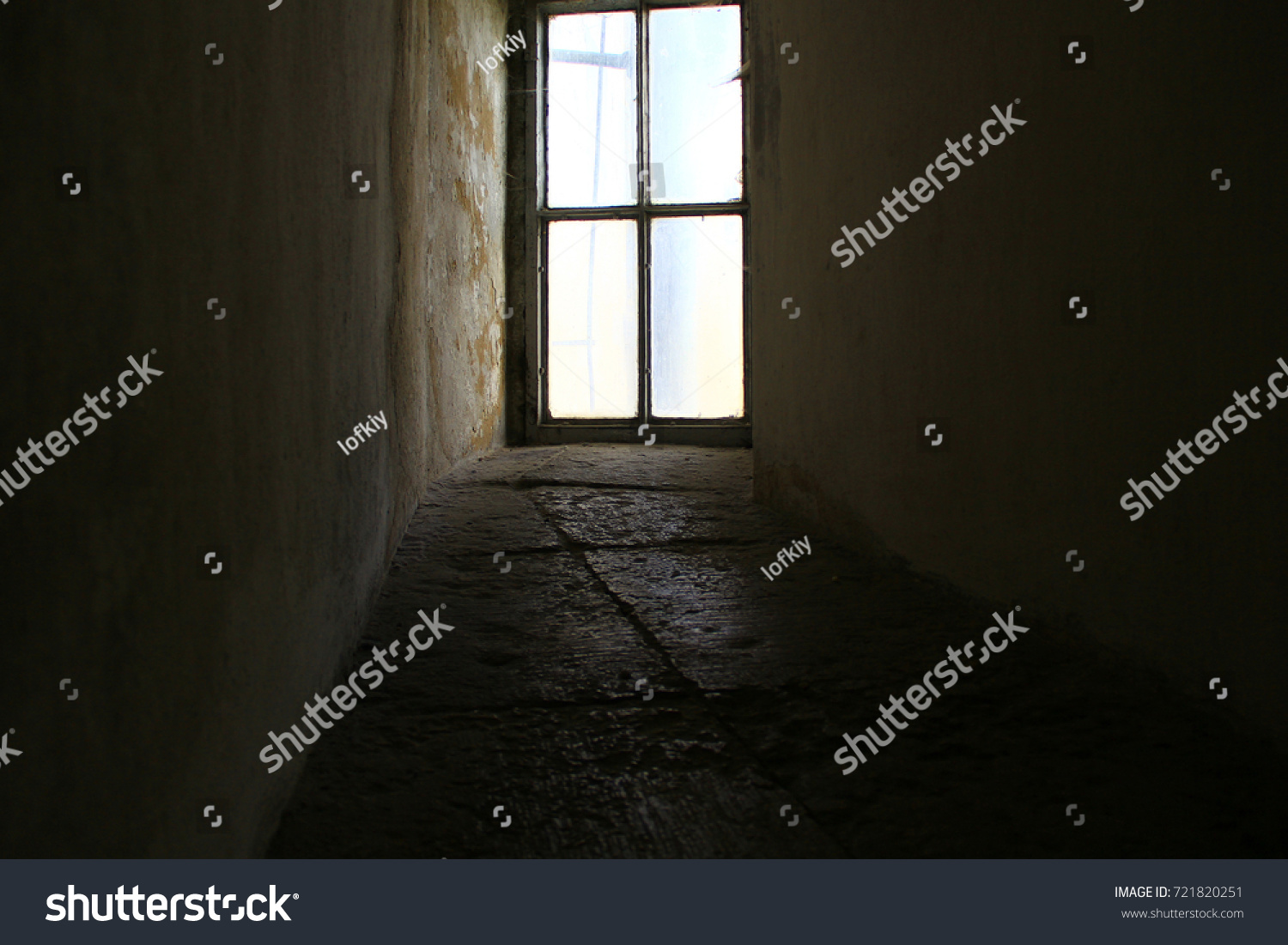 An ancient window at the end of a stone corridor #721820251