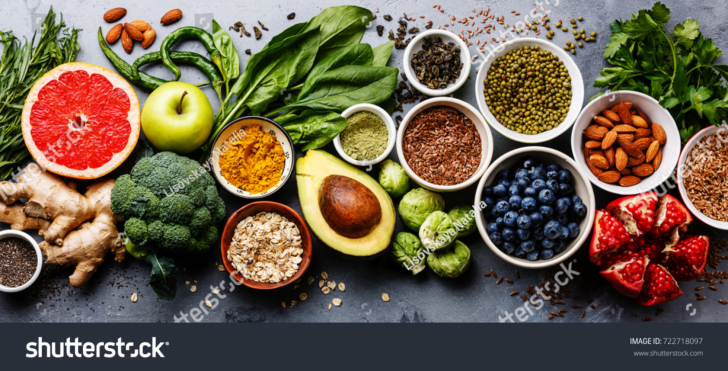 Healthy food clean eating selection: fruit, vegetable, seeds, superfood, cereal, leaf vegetable on gray concrete background #722718097