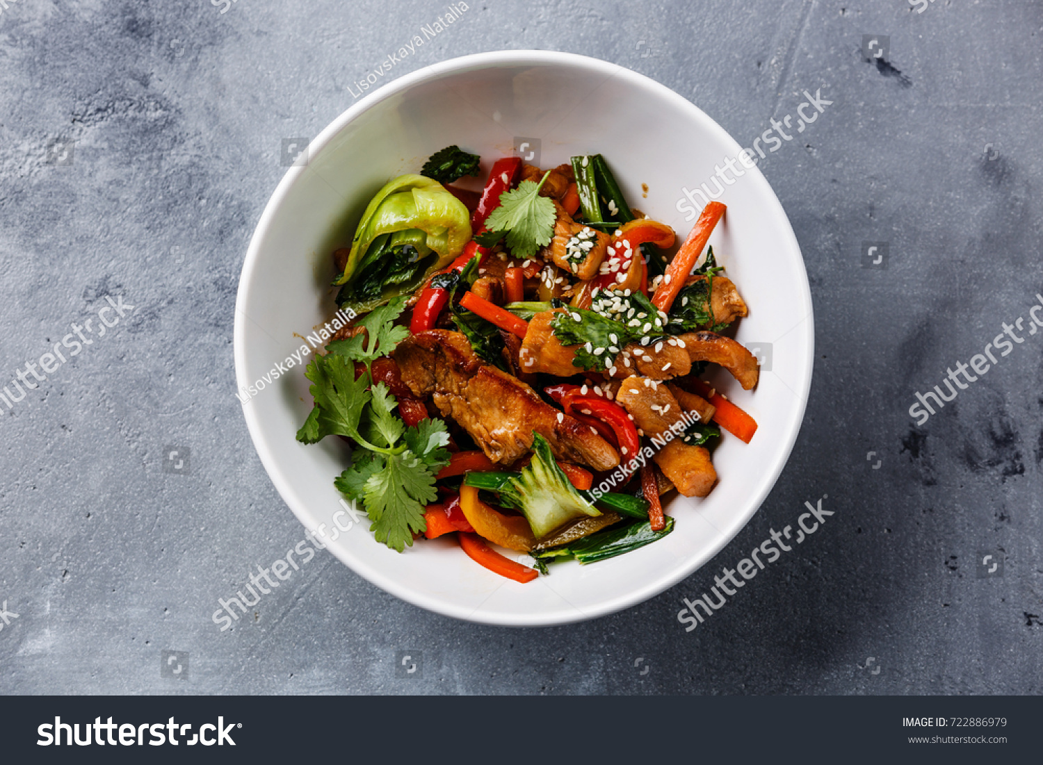 Chicken meat with vegetable in bowl stir fry on wok on concrete background #722886979
