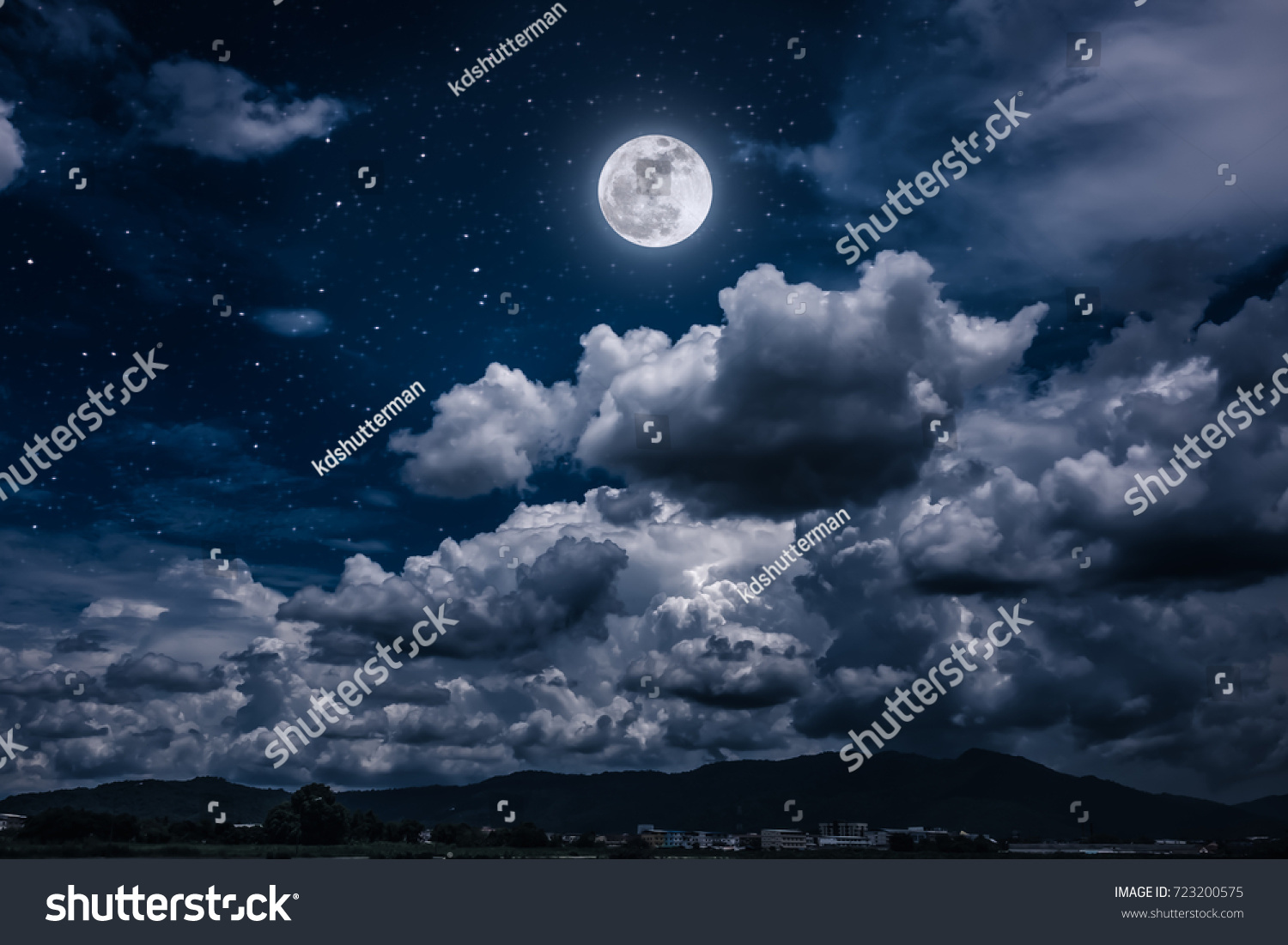 Beautiful cloudscape with many stars. Night sky with bright full moon and dark cloudy above mountain range among town. Serenity nature background. The moon taken with my own camera. #723200575