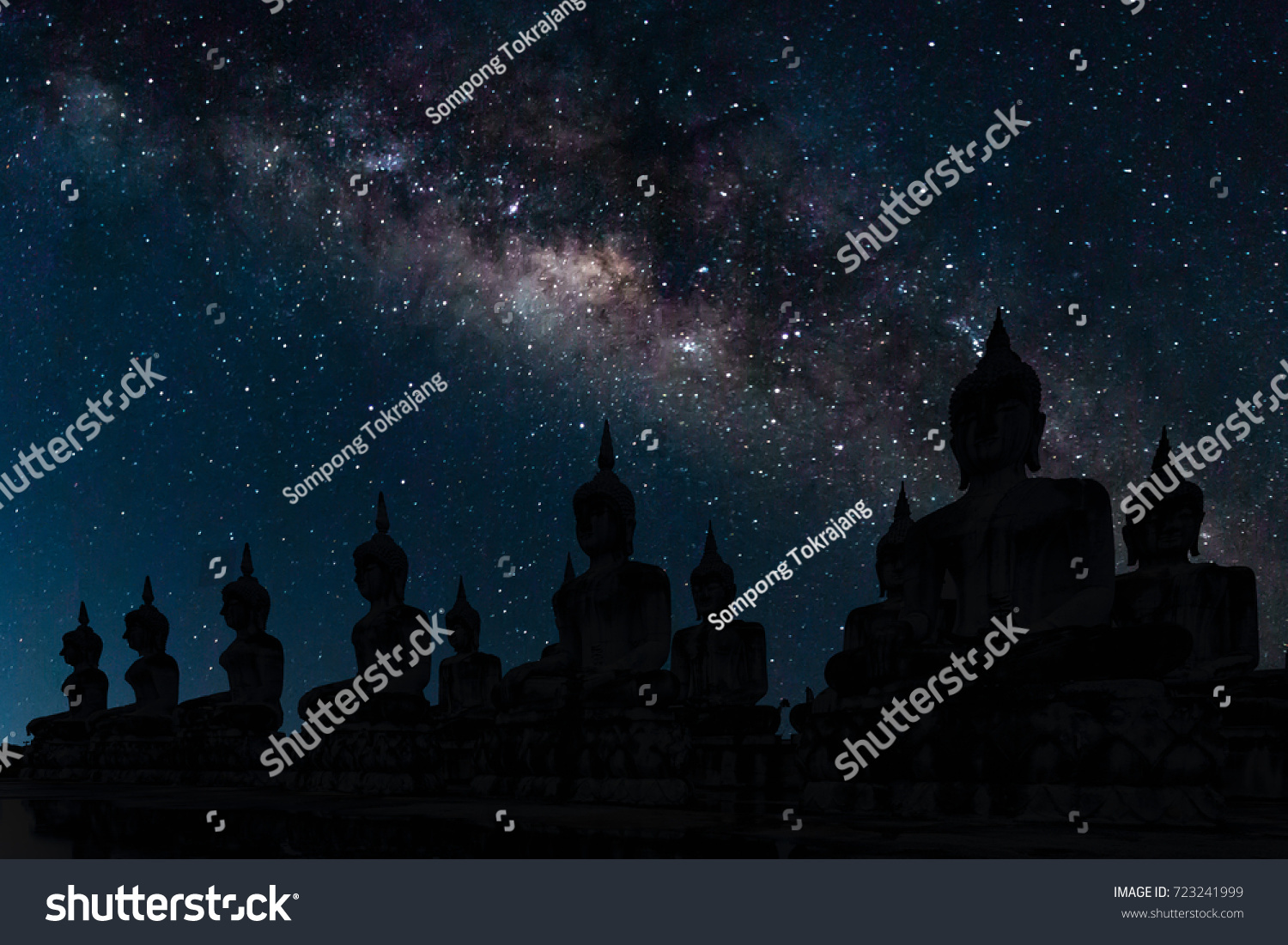 The milky way over Buddha to be used as background, Thailand. All buddha statue in Thailand is public domain. #723241999