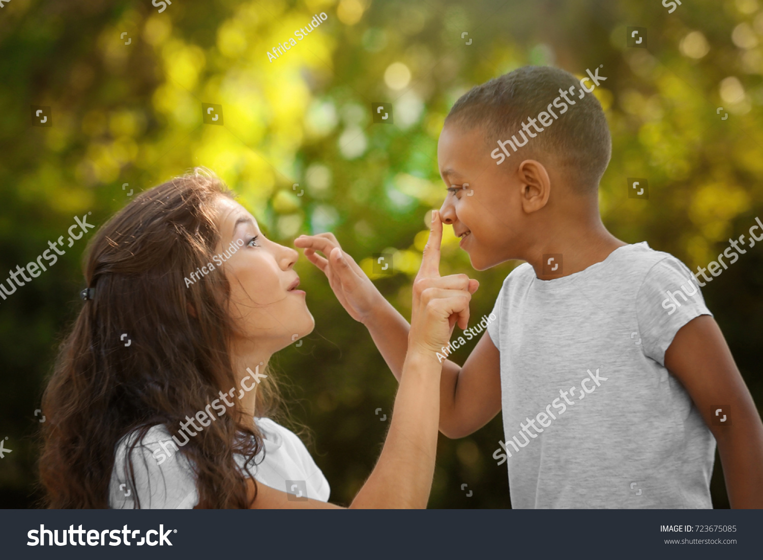 Young woman with adopted African American boy outdoors #723675085