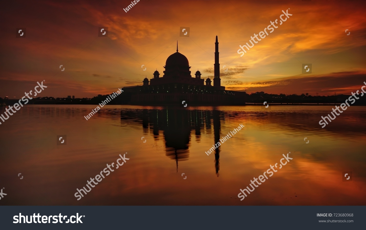 Silhouette Beautiful sunrise over the majestic mosque, Putra Mosque (Masjid Putrajaya). Soft focus due to slow shutter shot. #723680968