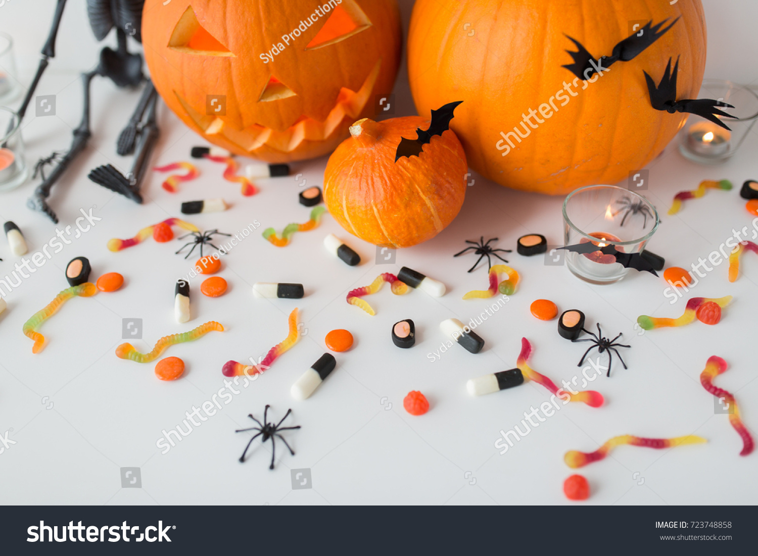 halloween, holidays and decoration concept - jack-o-lantern or carved pumpkins with candles on white background #723748858